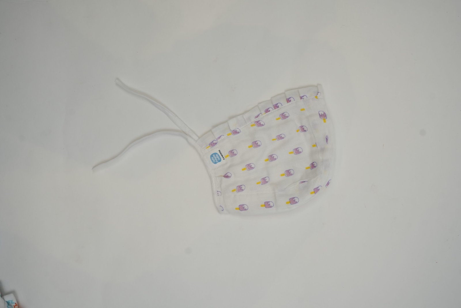 muslin cap with colorful popsicle pattern